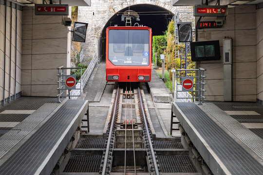 Lyon, France - July 27, 2026: Red Saint-Just funicular train at the station platform next to the tunnel entrance in Vieux Lyon.