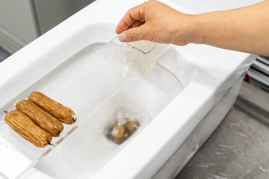 Test the toilet's flushing ability by dropping an object into it.