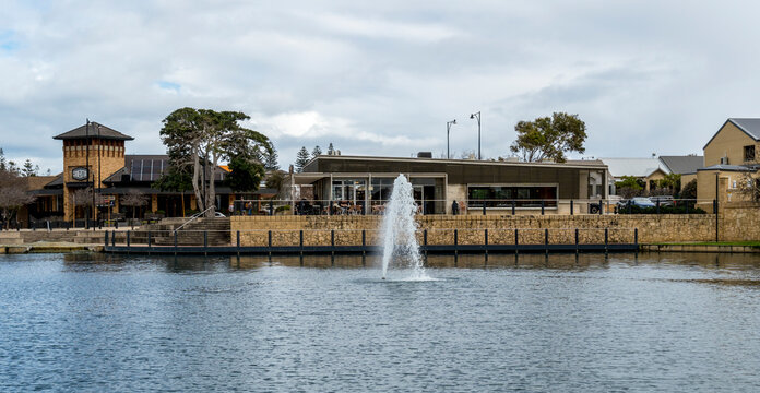 Lake fountain and waterfront cafe buildings at Brampton Park Butler suburb, Perth, Western Australia, 19 July 2026