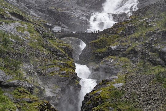 Motorhome on a bridge in front of heavily swollen Stigfossen waterfall, Trollstigen, near &Aring;ndalsnes or Andalsnes, Rauma municipality in the province of M&oslash;re og Romsdal, Norway