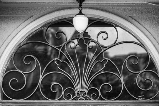 French Style Transom Window with Wrought Iron Metal Grate.