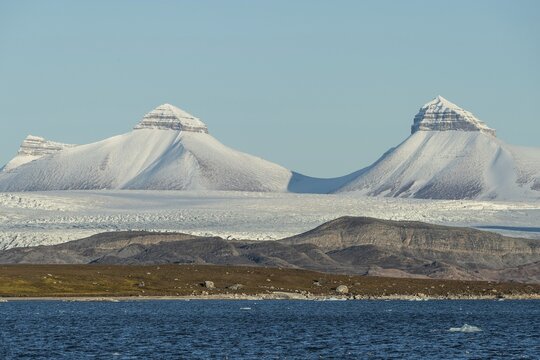 A fjord with ice floes and two of the three mountains: Tee Kroner (Three Crowns), Kronebreen or Kronengletscher Glacier, Kongsfjord or Kongsfjorden, the Svalbard archipelago, Svalbard, Norway