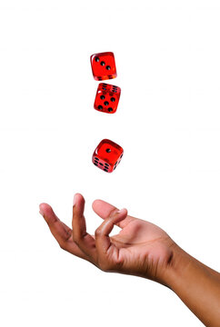 Hand rolling red dice mid-air over transparent background for games and chance concepts