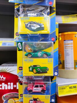 Malang, Indonesia - July 18, 2026: Three packaged Matchbox Collectors die-cast cars&mdash;a Ford GT, Bizzarrini, and Honda N600&mdash;stacked vertically on a store shelf display rack.