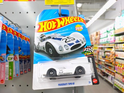 Malang, Indonesia - July 18, 2026: A white Hot Wheels "Maserati Tipo 61" die-cast toy car in its original blister card packaging hanging on a store rack.