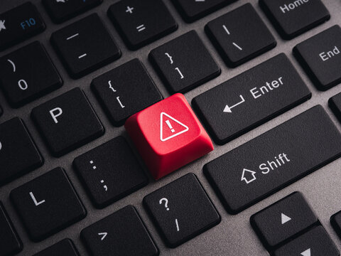 Red warning key on computer keyboard symbolizing cybersecurity threats, system alerts, malware detection, cyber attacks, security risks, critical errors, data protection, and IT security awareness.