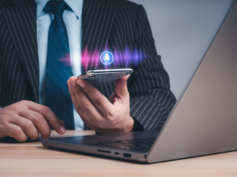 Business professional using smartphone with AI voice assistant interface. Voice recognition, speech-to-text technology, translation, mobile productivity, digital communication and business automation.