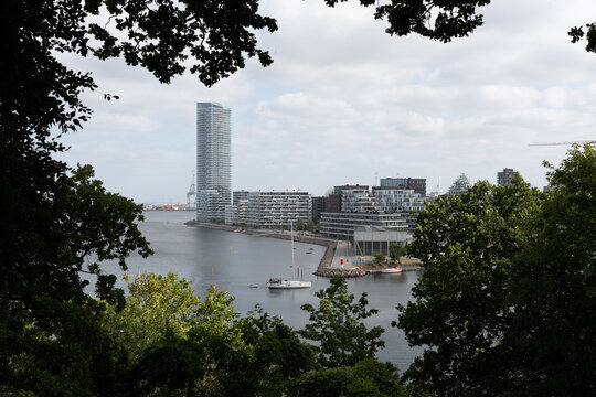 City skyline with riverfront harbor and modern skyscraper