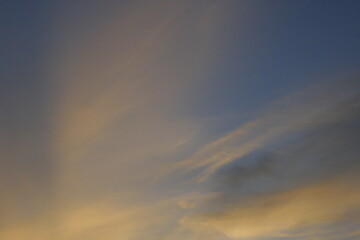 Fototapeta premium Soft golden clouds in the evening sky