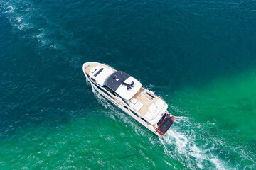 Fototapeta premium Aerial motorboat. Yacht boat tour. Luxury boat yachting. Motorboat sailing at sea. Luxury charter yacht in sea. Motor yacht luxury vessel. Sea motor boat. Sea summer vacation. Yacht lifestyle