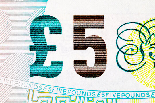 fragment of a British 5 pound banknote showing the Bank of England typography. United Kingdom national currency. Money of the world.