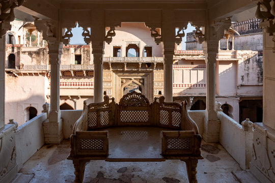 India. Rajasthan. Bundi. An ancient, intricately openwork throne, adorned with carved peacocks, stands on a terrace at Garh Palace