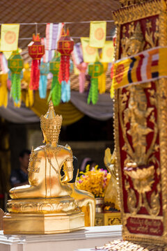 Golden Guardian Statue with Colorful Lanna Lanterns at Buddhist Temple Festival in Chiang Mai Thailand