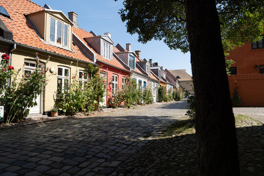 Charming European street with cobblestone path and historic rowhouses