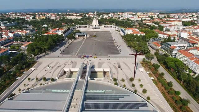 Expansive aerial view slowly revealing the sanctuary of fatima, including the basilica of the holy trinity and the basilica of our lady of the rosary, a major catholic pilgrimage site in portugal