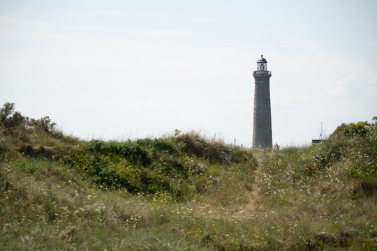 Coastal Lighthouse Standing Above Sand Dunes