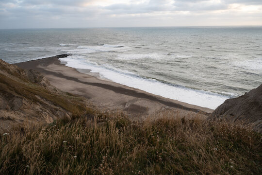 Rocky Coastal Beach with Ocean Waves and Dramatic Shoreline