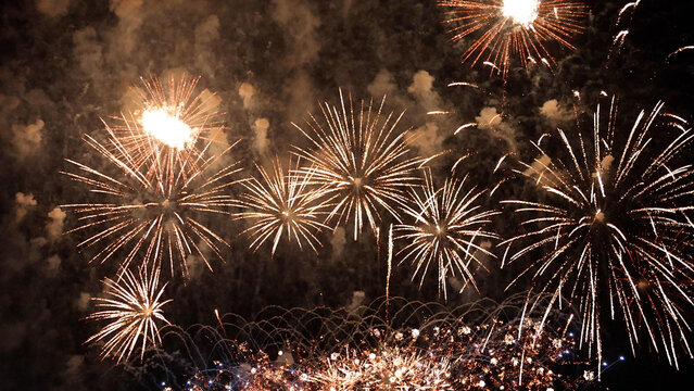 Amazing real beautiful colorful fireworks background on celebration night event for happy new year party, independence day, festivals, Abstract Multi color golden firework in the night sky