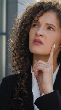 Close up Caucasian puzzled business woman thinking doubtful think job difficulty female girl concerned businesswoman pondering startup project problem question planning ponder trouble in city downtown