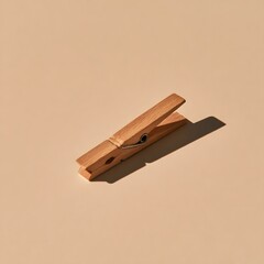 Fototapeta premium Minimalist wooden clothespin peg on soft beige background