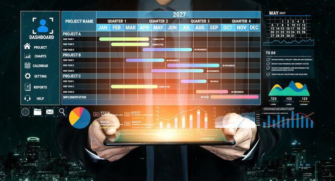 Businessman Holding Tablet Displaying Project Management Dashboard with Gantt Chart, Calendar, and Data Visualizations for 2027 Planning and Analysis Fluxor.