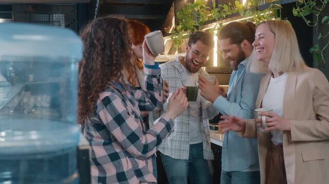 Cheerful diversity people five friends business team men women dancing drinking coffee in office cafe laughing enjoying dance listening music together break pause friendly buddies drink having fun joy