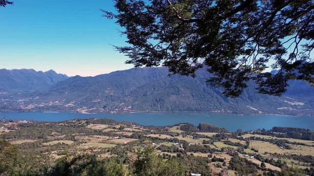 Drone Shot Revealing Woman Swinging Toward Mountains And Water In Cochamo Chile