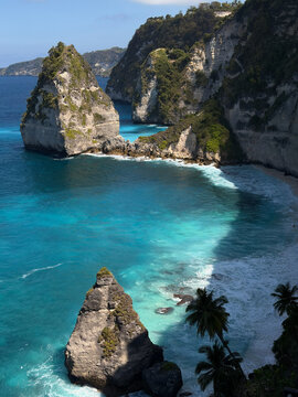 A scenic coastal view featuring rugged cliffs and clear blue waters. Diamond beach in Nusa penida, Bali