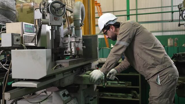 Engineer factory machine helmet worker industry tool metal safety glove technician operating lathe equipment workshop maintenance