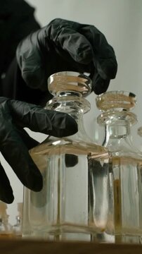 Gloved Hand Closing Glass Perfume Bottle During Fragrance Product Development