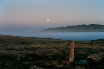 Fototapeta premium Alpine tundra at twilight with ground fog and boundary post