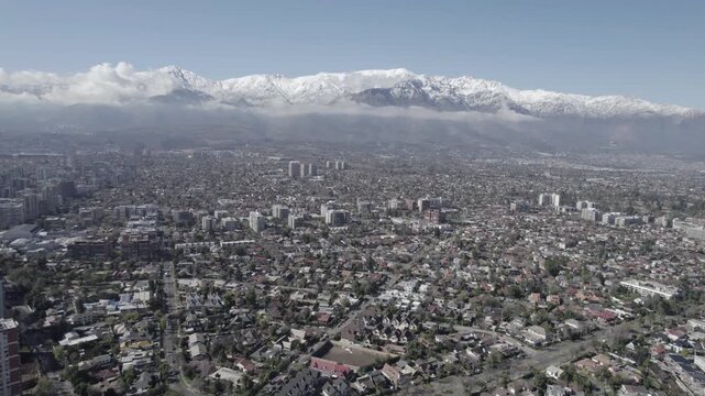 Aerial Drone Shot Of Santiago De Chile Urban Sprawl And Snow-Capped Andes Mountains 