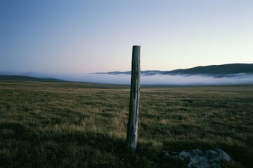 Fototapeta premium Alpine tundra at twilight with ground fog and boundary post