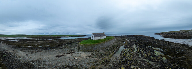 Aerial panorama of the Church in the Sea - St Cwyfan's church (Eglwys Cwyfan), Anglesey, Wales © Julian Gazzard