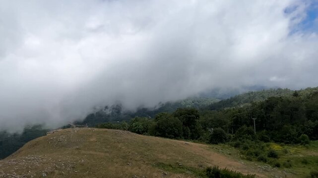 Massive Clouds Rolling Over Forested Mountain Ridge in Kartepe, Turkey captured in a dynamic summer nature scene, showing visible cloud movement across the Kartepe mountain landscape in Turkey.