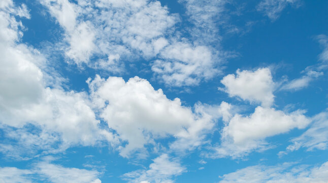 Sky with fluffy white cloudscape texture. Blue sky nature background, horizontal