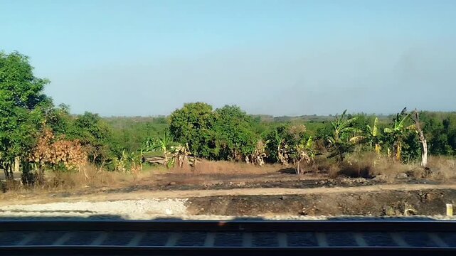 Sunset view outside the window from a moving train. traveling by train transportation
