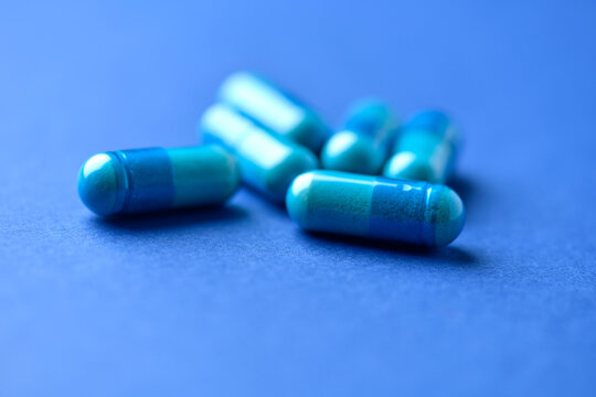 Amino acids capsules on paper background. Soft focus. Close up.