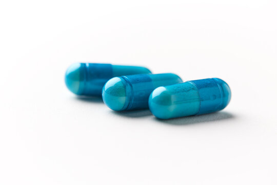 Amino acids capsules on paper background. Soft focus. Close up