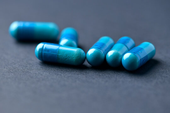 Amino acids capsules on paper background. Soft focus. Close up