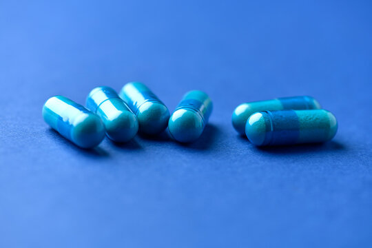 Amino acids capsules on paper background. Soft focus. Close up