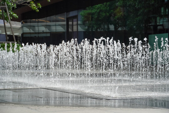 Modern water jets create a refreshing cascade in a contemporary urban plaza