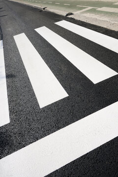Close-up of a newly painted European zebra crossing.