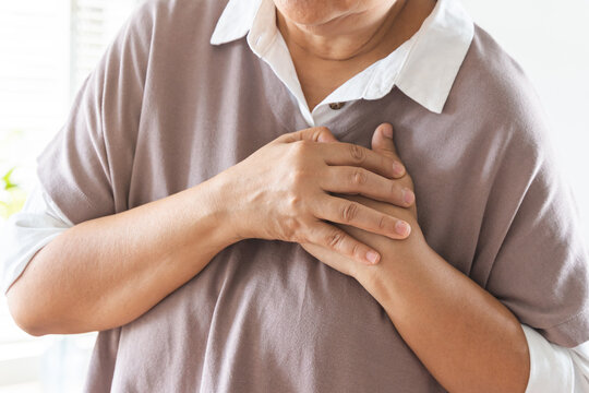 Chest pain, attack chest, emergency heartbeat asian senior woman holding hand on chest, suffering symptom from pain, heart disease problem of aged anxiety cardiac. Health care of cardiology concept.