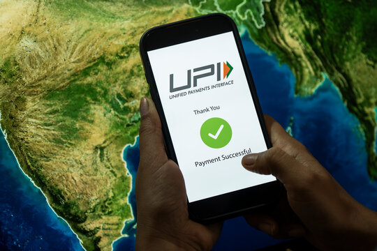 In this photo illustration, A smartphone displaying a successful UPI payment is held in front of a map highlighting India, illustrating the country&rsquo;s growing digital payment ecosystem