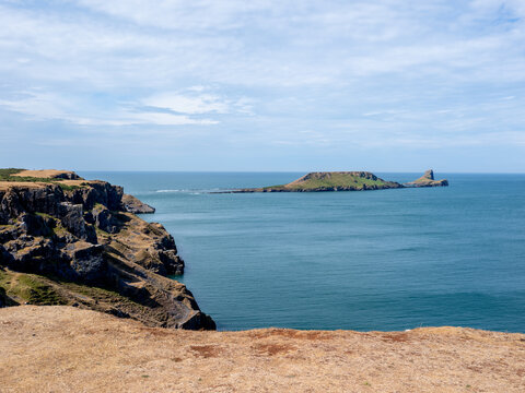 Rhossilli beach and Worms head in the Gower  on a hot summer day