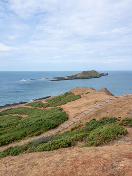 Rhossilli beach and Worms head in the Gower  on a hot summer day