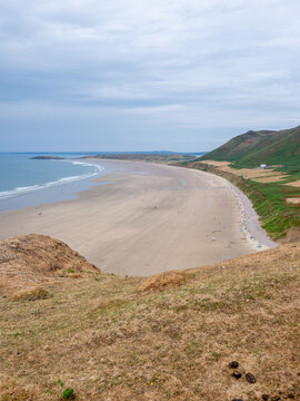 Rhossilli beach and Worms head in the Gower  on a hot summer day