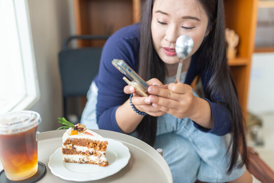 Woman Enjoying Dessert and Drinking Tea at Cafe