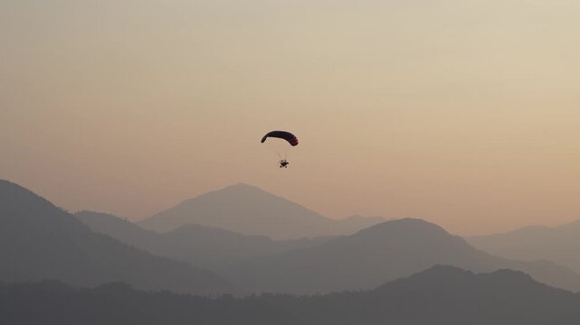 Paramotor flying over Laos during a clear sunrise, 4k 50 fps, Sony Images, 16:9